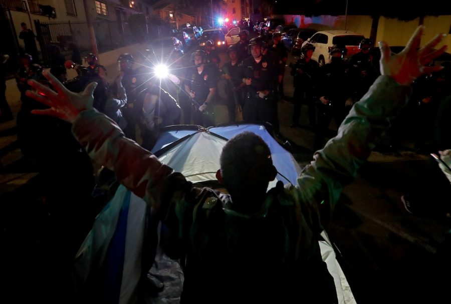 Homeless man sets up tent in front of LAPD. (Los Angeles Times) 