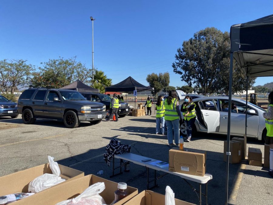Cars pulling up to the Pico Rivera Holiday Drive-thru station for boxes of food.
