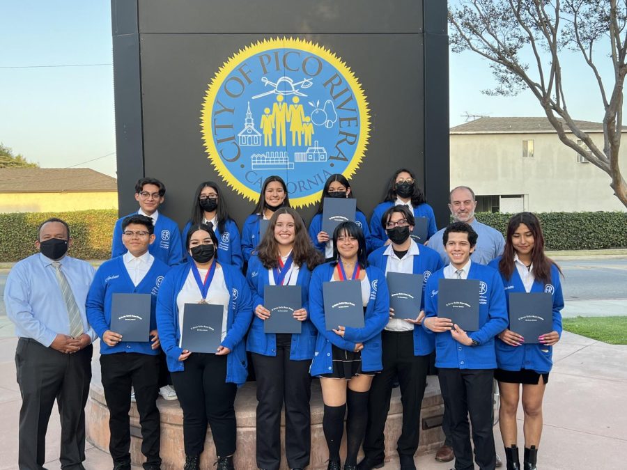 The Academic Decathlon team in front of City Hall with their certificates.